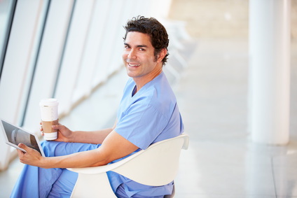 Doctor Using Digital Tablet On Coffee Break In Hospital